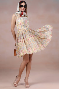 Woman wearing a floral dress with a scarf on a beige background