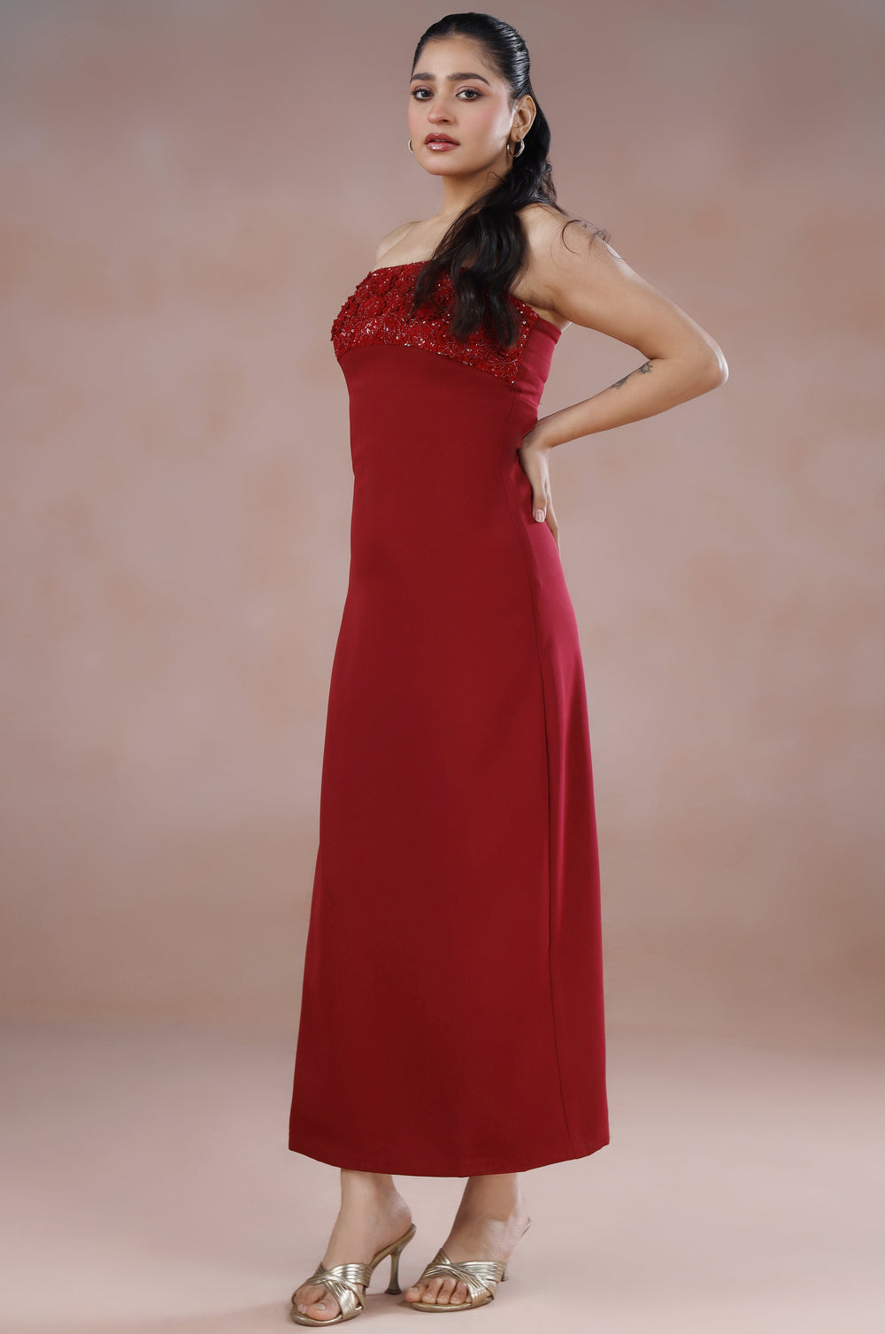 Woman wearing a red dress against a plain background