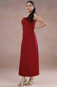 Woman wearing a red dress against a plain background