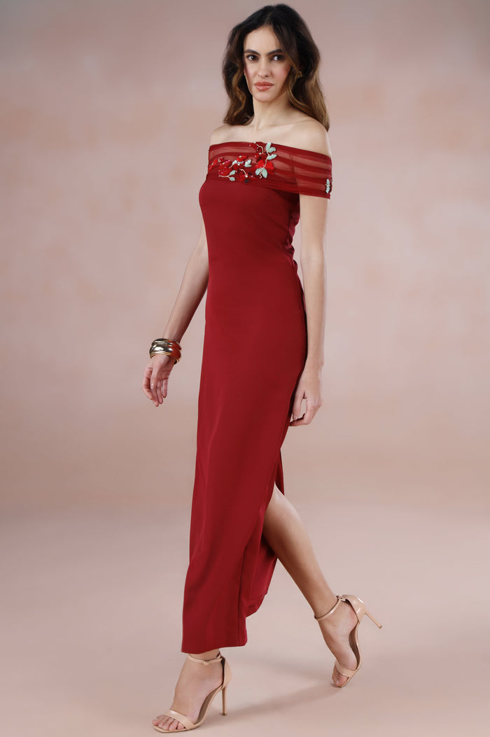 Woman wearing a red off-shoulder dress on a beige background