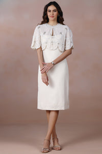 Woman wearing a white dress with a textured pattern against a gradient background
