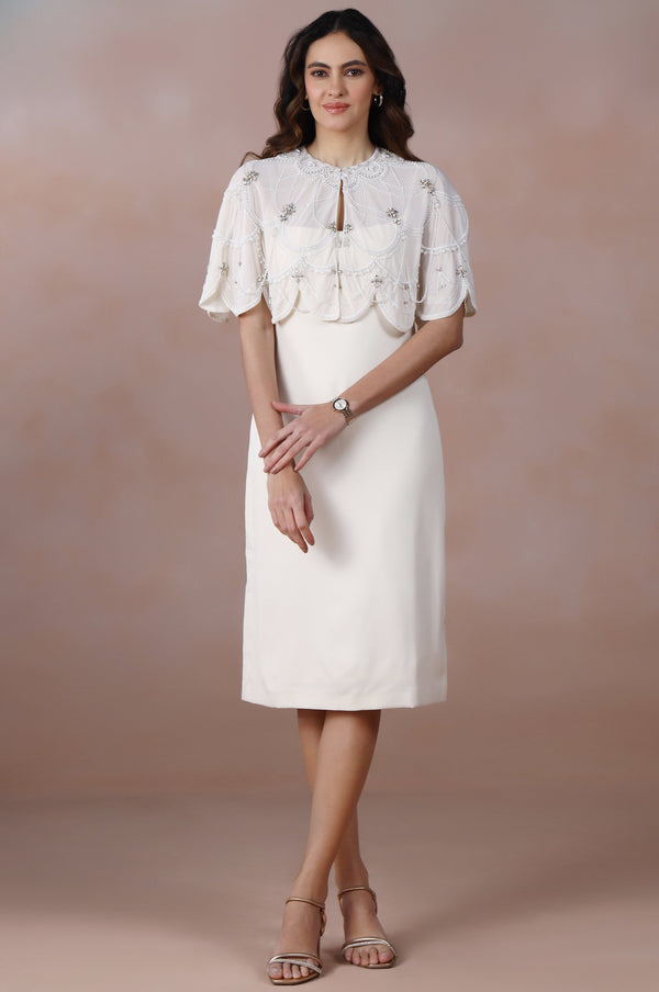 Woman wearing a white dress with a textured pattern against a gradient background