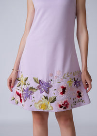 Lavender dress with floral embroidery on a plain background